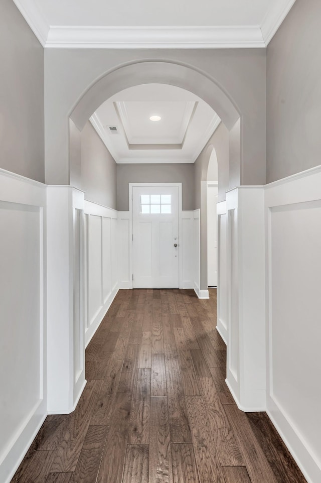 hallway with ornamental molding and dark hardwood / wood-style flooring