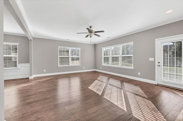 spare room featuring ornamental molding, plenty of natural light, dark hardwood / wood-style floors, and ceiling fan