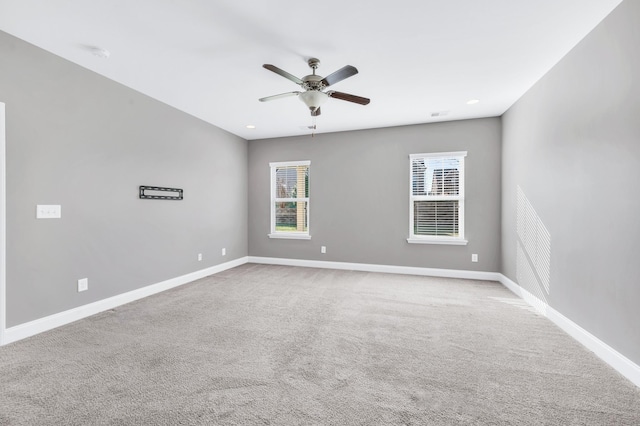 unfurnished room featuring ceiling fan and light carpet