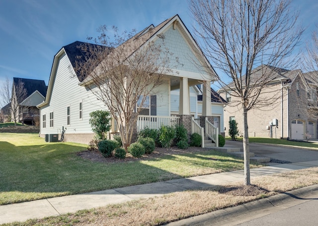 view of front facade with a front yard, central AC unit, and covered porch