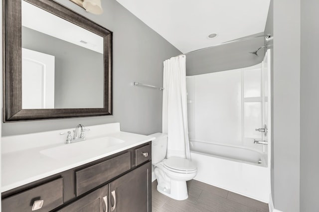 full bathroom featuring shower / bath combination with curtain, vanity, and toilet