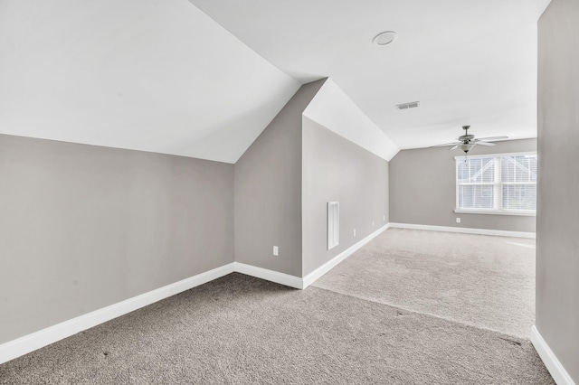 additional living space with carpet, lofted ceiling, and ceiling fan