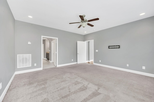 carpeted spare room featuring ceiling fan