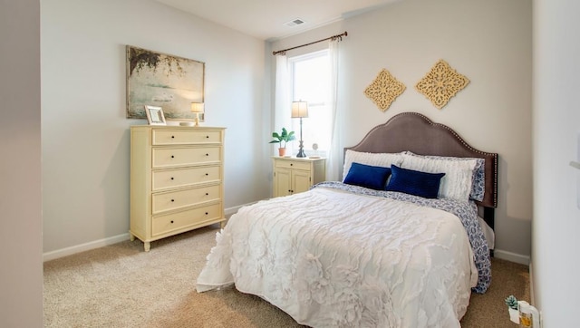 bedroom featuring light colored carpet