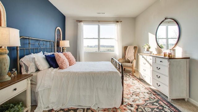 carpeted bedroom with lofted ceiling