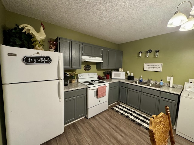 kitchen with washer / dryer, sink, gray cabinetry, and white appliances