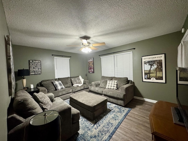 living room featuring hardwood / wood-style floors, a textured ceiling, a wealth of natural light, and ceiling fan