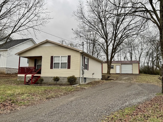 view of front of house with a garage, an outdoor structure, and covered porch