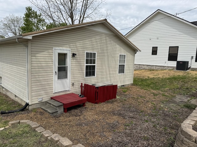 rear view of property with central AC and crawl space