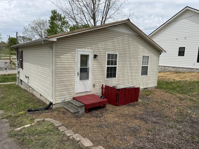 rear view of house featuring crawl space