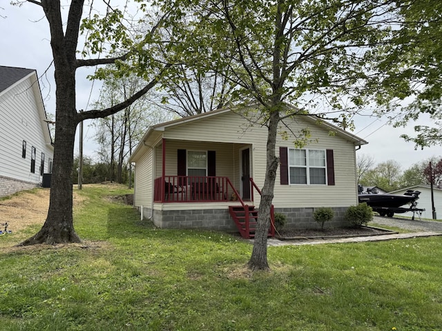 bungalow with a porch and a front yard