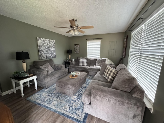 living room with wood finished floors, a textured ceiling, a ceiling fan, and baseboards