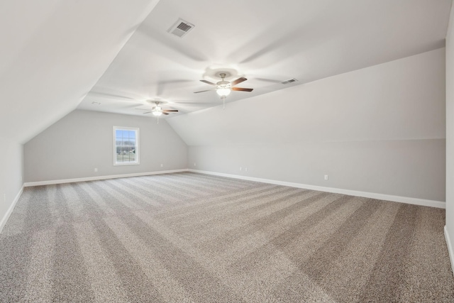 additional living space featuring ceiling fan, lofted ceiling, and carpet floors