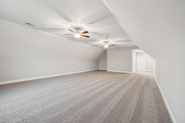 bonus room with visible vents, light carpet, baseboards, lofted ceiling, and ceiling fan