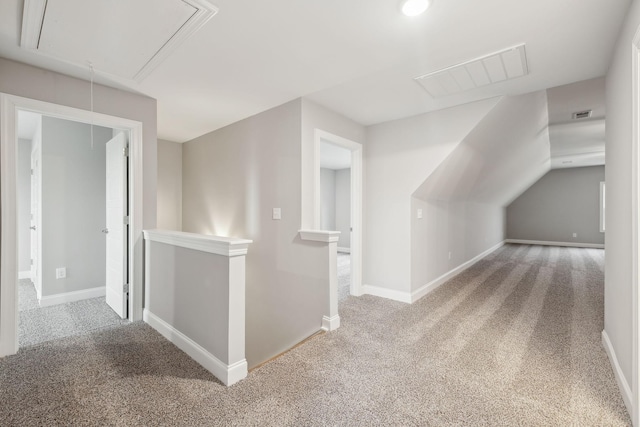 bonus room featuring visible vents, baseboards, carpet, and attic access