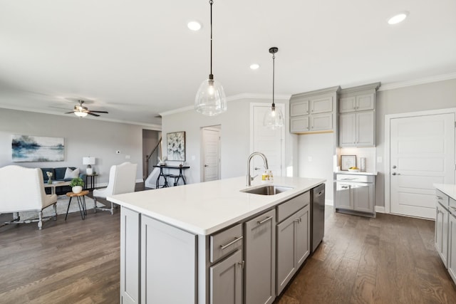 kitchen featuring dishwasher, crown molding, gray cabinets, and a sink