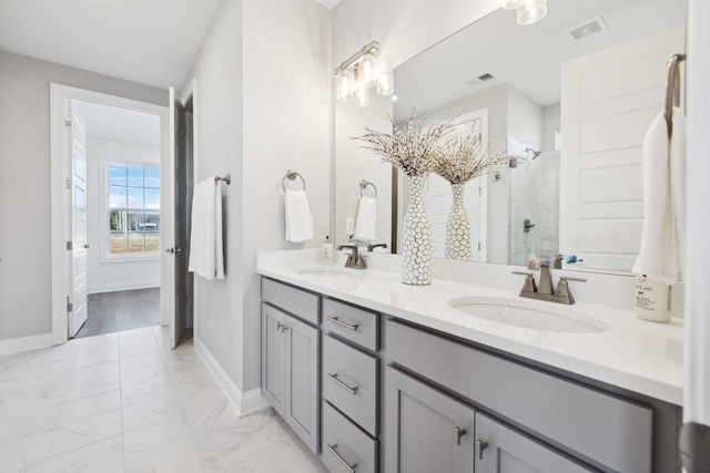 full bathroom featuring visible vents, marble finish floor, a shower stall, and a sink