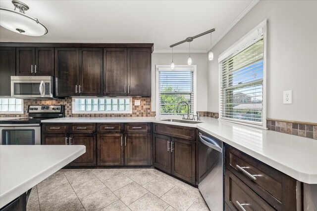 515 E 4th St, Cookeville, TN 38501 - kitchen with stainless steel appliances, ornamental molding, tasteful backsplash, light countertops, and dark brown cabinetry