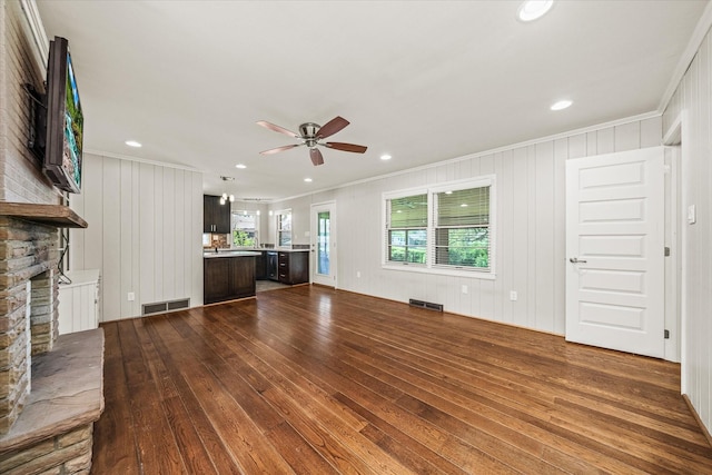 515 E 4th St, Cookeville, TN 38501 - unfurnished living room with dark wood-style flooring, a ceiling fan, ornamental molding, a fireplace, and recessed lighting