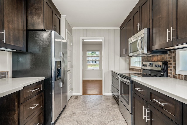 515 E 4th St, Cookeville, TN 38501 - kitchen with stainless steel appliances, ornamental molding, tasteful backsplash, dark brown cabinetry, and light countertops