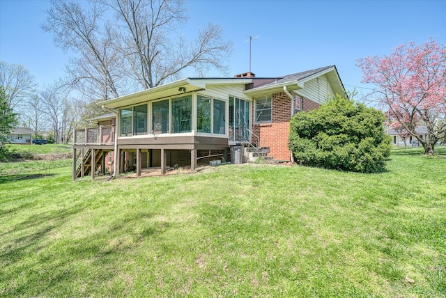 515 E 4th St, Cookeville, TN 38501 - rear view of house featuring a sunroom, stairway, a lawn, and brick siding