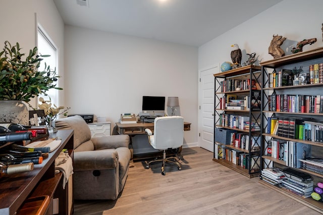 office space with light hardwood / wood-style floors