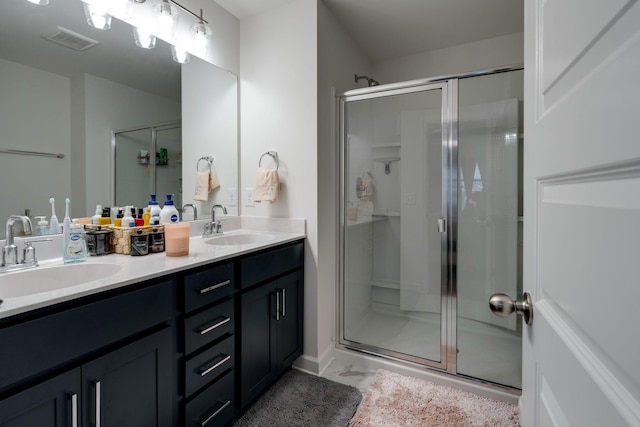 bathroom with walk in shower and vanity