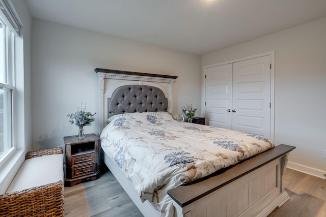 bedroom with hardwood / wood-style flooring and a closet