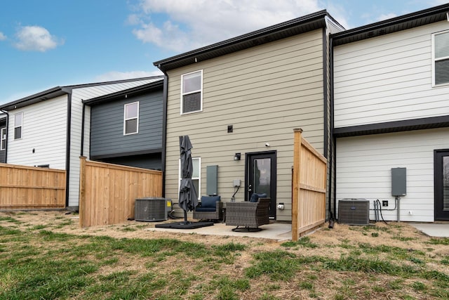 back of house featuring central AC, a yard, and a patio area