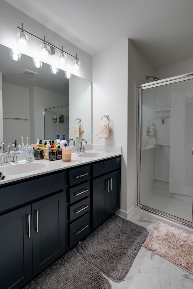 bathroom with vanity and a shower with door