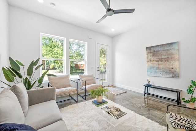 living room featuring concrete floors and ceiling fan