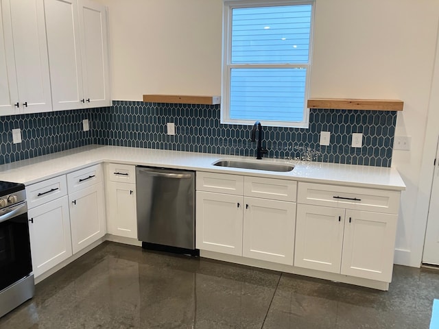 kitchen with tasteful backsplash, sink, white cabinets, and appliances with stainless steel finishes