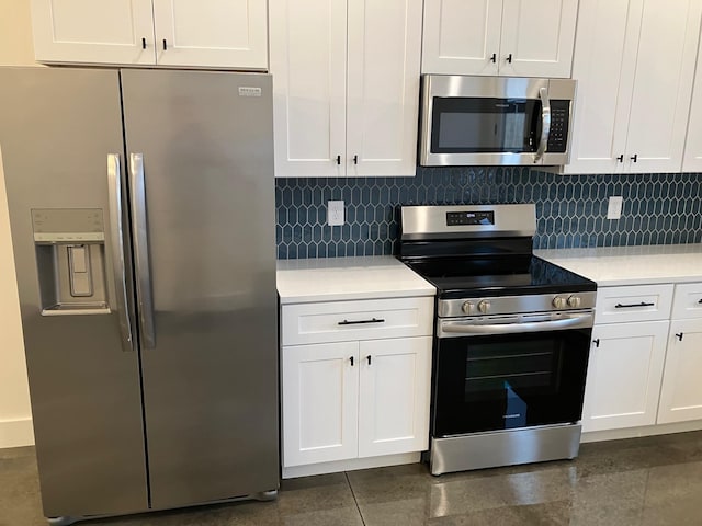 kitchen featuring tasteful backsplash, white cabinets, and appliances with stainless steel finishes