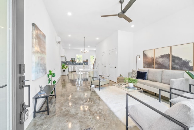 living room featuring concrete flooring and ceiling fan with notable chandelier