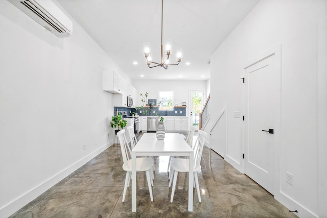 dining space featuring concrete flooring, a wall unit AC, and a chandelier