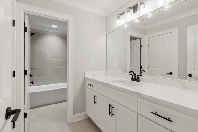 bathroom with tiled shower / bath, ornamental molding, and vanity