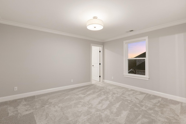 carpeted spare room featuring ornamental molding