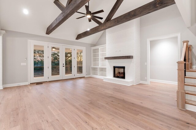 unfurnished living room with high vaulted ceiling, a brick fireplace, light hardwood / wood-style flooring, beamed ceiling, and ceiling fan