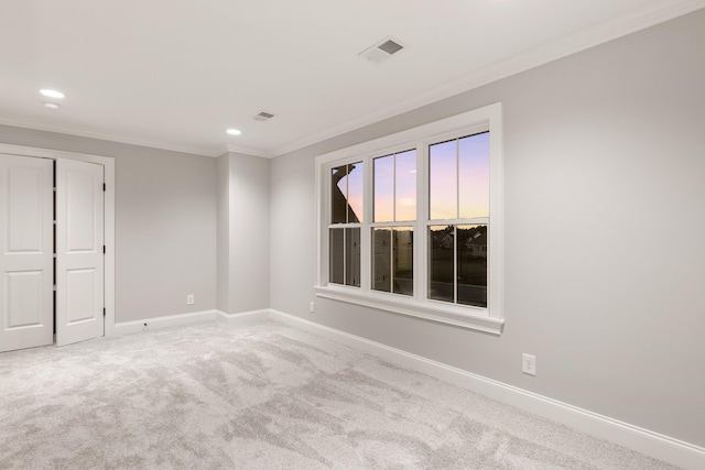 unfurnished room featuring ornamental molding and carpet flooring