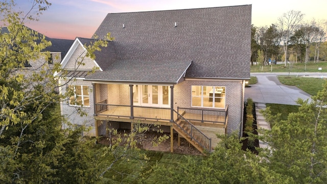 back house at dusk with a deck