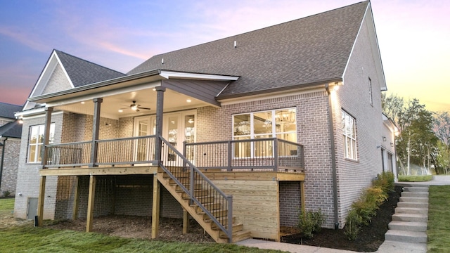 back house at dusk featuring ceiling fan