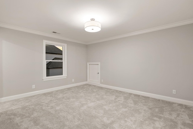 spare room with light carpet and ornamental molding