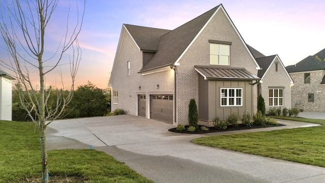 property exterior at dusk featuring a garage and a yard