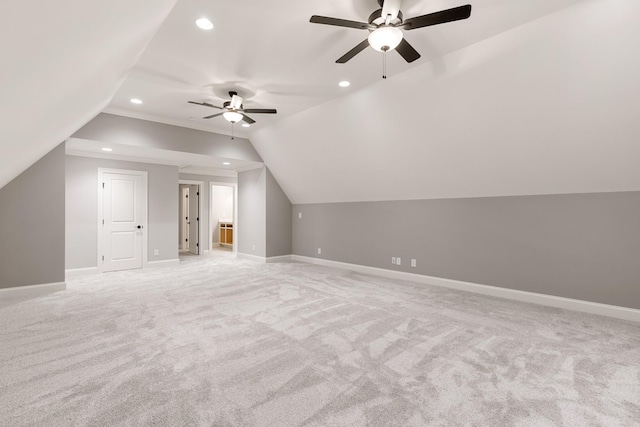 additional living space with vaulted ceiling, light carpet, and ceiling fan