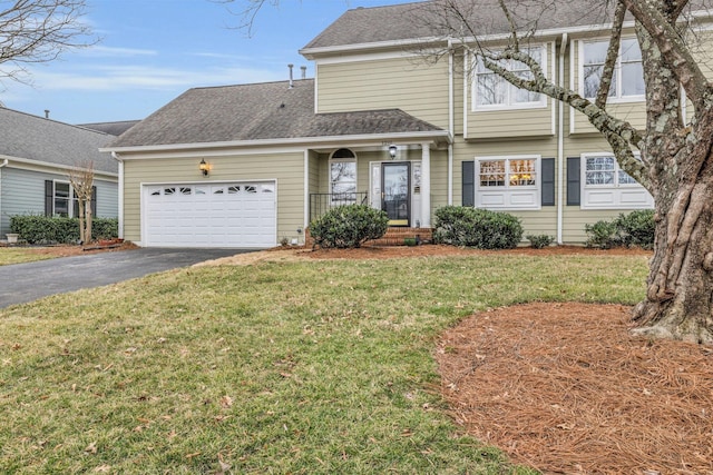 view of front of property featuring a shingled roof, a front lawn, driveway, and an attached garage