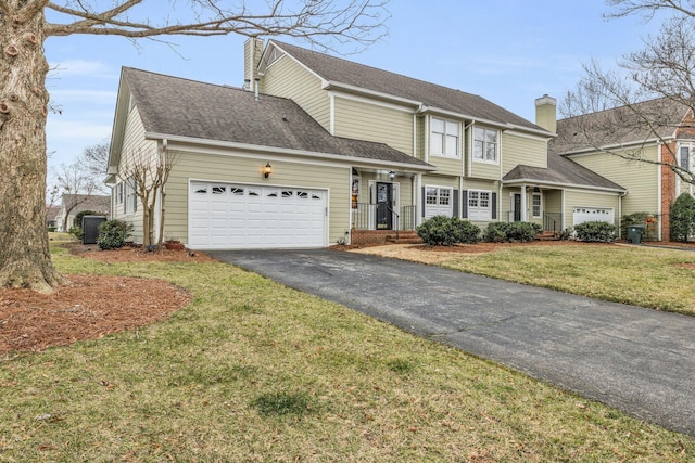 traditional home with a front yard, driveway, a garage, a shingled roof, and a chimney