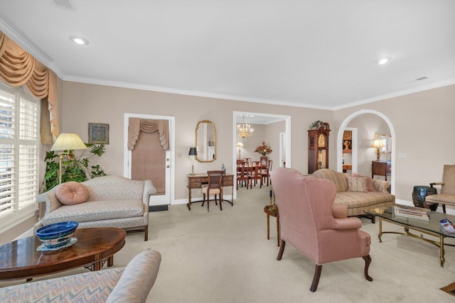 living room with light carpet, a notable chandelier, crown molding, and arched walkways