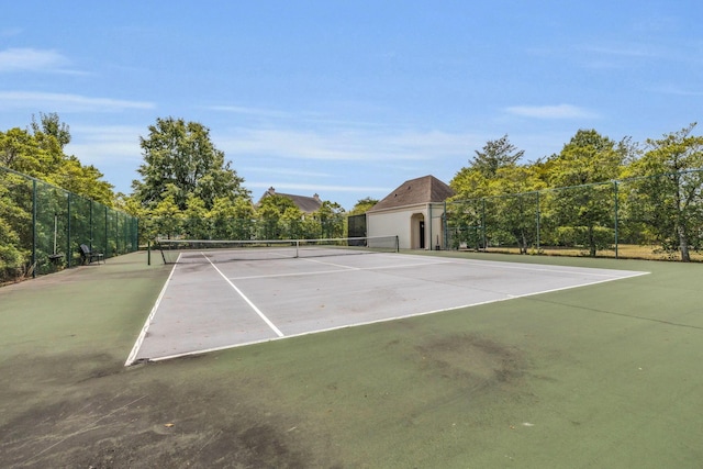 view of tennis court featuring fence