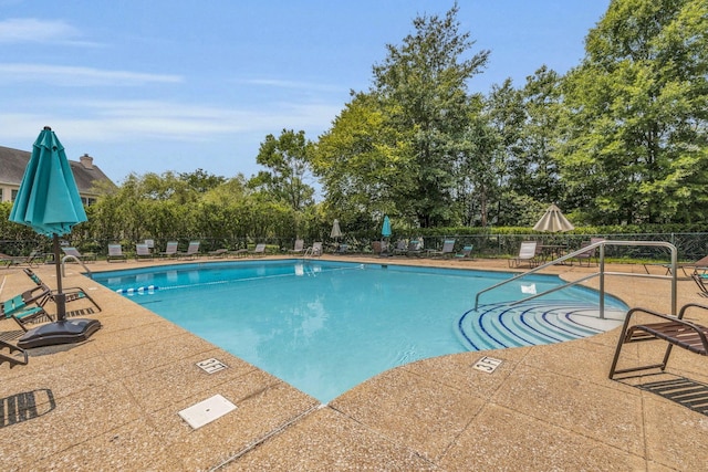 pool featuring fence and a patio