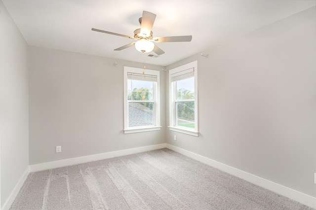 carpeted spare room with ceiling fan